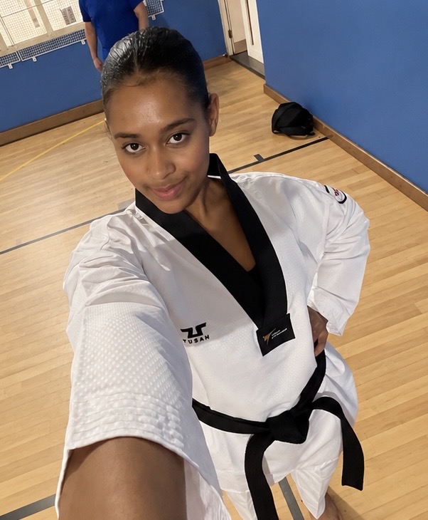 Andrea in her taekwondo dobok standing on the training hall floor