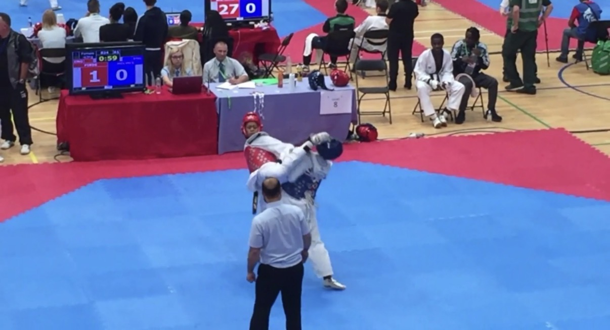 Andrea mid-fight at a taekwondo competition